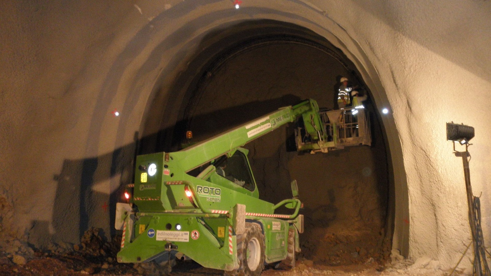 Tunnel arch completion with boom lift inspection
